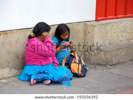 BOGOTA, COLOMBIA - APRIL 06, 2014: An unidentified homeless woman and child in the streets of Bogota Colombia. The World Bank estimates that one in three people live below the poverty line in Colombia