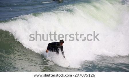IMPERIAL BEACH, CALIFORNIA - June 3, 2015: People surfing at Imperial Beach California. Imperial Beach is the southernmost beach city in Southern California and the West Coast of the United States
