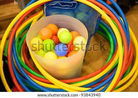 Bucket of plastic balls and some colorful hula hoops