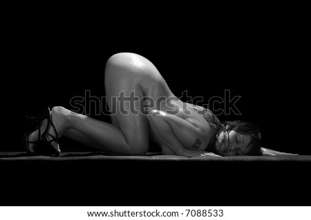 stock photo : naked woman with tattoo on black background