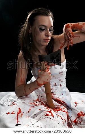 sad woman with axe with blood on black background