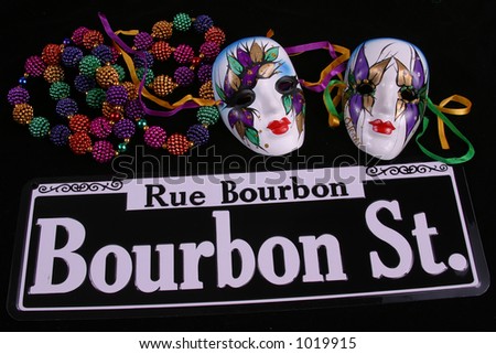 stock photo : Bourbon Street sign, beads and two masks for Mardi gras.