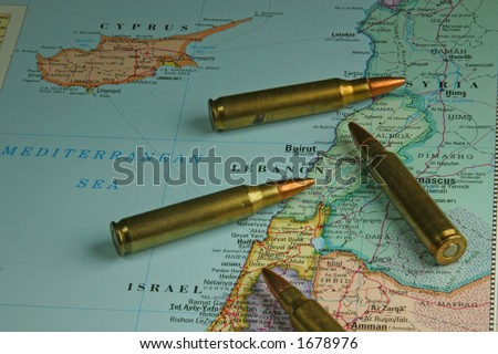 Map of Israel and Lebanon with rifle ammo laying on it.