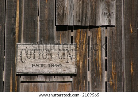 Old weathered Cotton Gin sign close up.