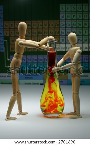 Two wood manikins conducting a science experiment with a chart in the background.