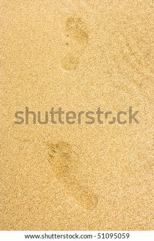 Footprints on smooth sand ground.