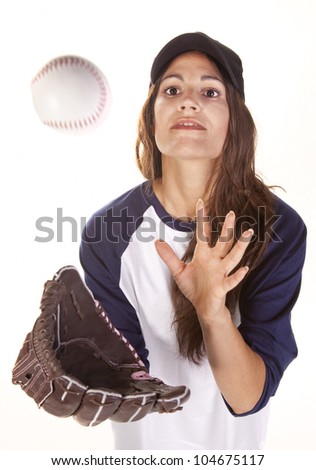 Woman baseball or Softball player isolated on white in the act of catching a baseball.
