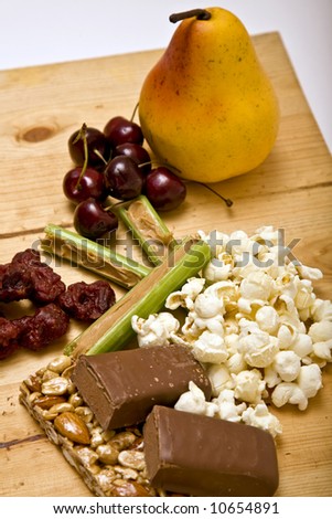 Healthy alternative snacks and foods such as fruit (pear and  cherries), popcorn, celery and peanut butter, nutbar, food bar and  jerky.