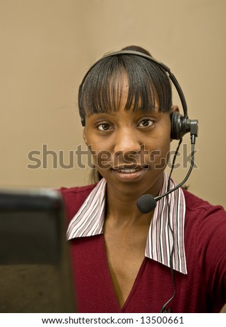An attractive African American customer support representative, office worker or business  woman.