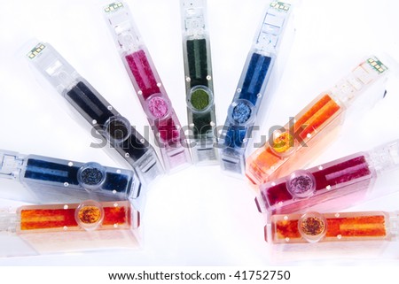 Colorful inkjet printer cartridges empty,  ready for recycling and arranged in a  semi-circle.
