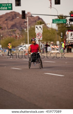 SCOTTSDALE, AZ - JANUARY 17:   An unidentified wheelchair competitor races in the P.F. Chang\'s Phoenix Arizona Marathon on January 17, 2010 in Scottsdale, AZ.