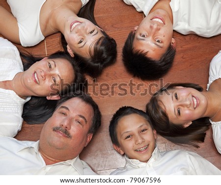 multicultural American family photographed from above laying in a ring.
