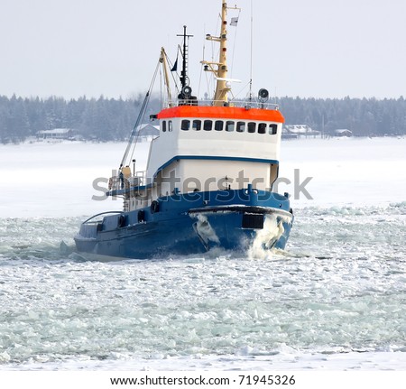 Tug boat breaking ice