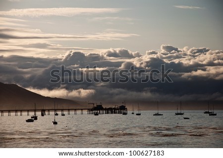 Early morning view of a pier and the coastal mountains of central California on the San Luis Obispo Bay.