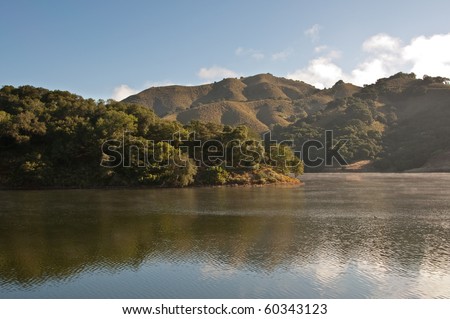 The morning light hits the rolling hills and chaparral of the central California on Uvas Reservoir.