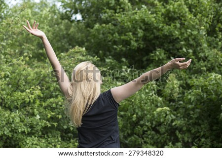 Beauty Women enjoying nature on the field. Beautiful slim girl Outdoor raising hands.