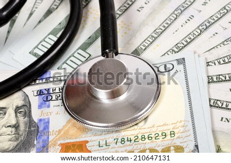 Medical still life with stethoscope and dollars with selective focus effect