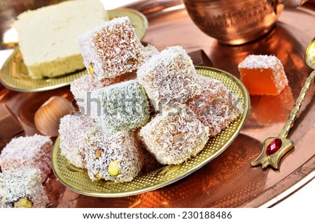 Close-up of Turkish delight, halva and coffee on copper tray