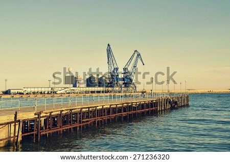 Commercial docks at sunset with a boat and cranes ,selective focus, Balchik, Bulgaria