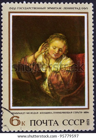 USSR - CIRCA 1973: A stamp printed in USSR shows State Hermitage Museum of Leningrad, the artist Rembrandt-Young woman earrings measure 1654, circa 1973
