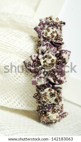 handmade bracelets with violet flower decoration in natural materials