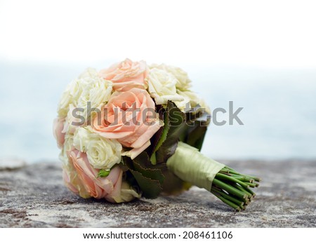 pink and beige roses wedding bouquet shallow dof