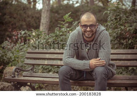 Guy sitting on a bench in the park