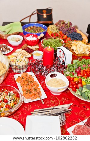 Table with lots of different foods for Christmas party.