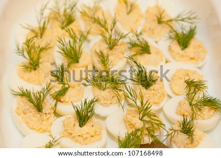 Deviled eggs or eggs mimosa are hard-boiled eggs cut in half and filled with the hard-boiled egg\'s yolk mixed with different ingredients.