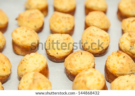 Cheese and spinach puff pastry appetizers on party table.
