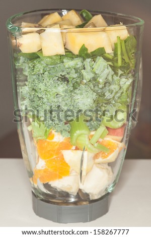 Home made fruit and vegetable smoothie blended from spinach, kale,celery, banana, orange, apple, pineapple and coconut juice.