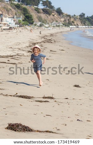 Having fun running on the beach on sunny day.