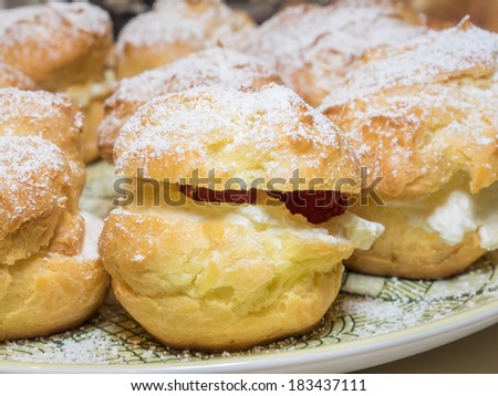 Homemade choux pastry ball filled with whipped cream, pastry cream.