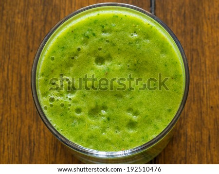 Home made fruit and vegetable smoothie blended from spinach, kale,celery, banana, orange, apple, pineapple and coconut juice.