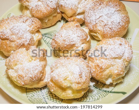 Homemade choux pastry ball filled with whipped cream, pastry cream.