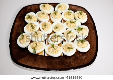 Deviled eggs or eggs mimosa are hard-boiled eggs cut in half and filled with the hard-boiled egg\'s yolk mixed with different ingredients. Deviled eggs are usually served cold.