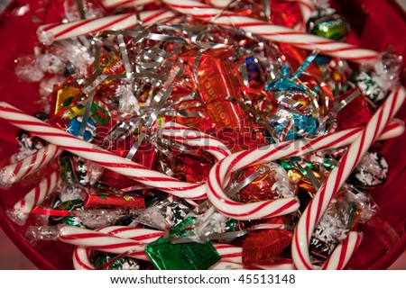 A candy cane is a hard cane-shaped candy stick. It is traditionally white with red stripes and flavored with peppermint or cinnamon