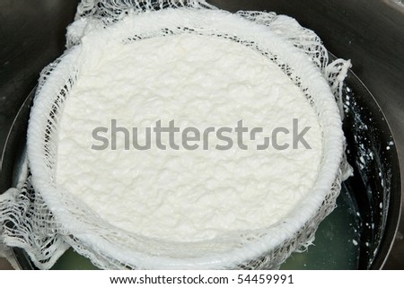 Cottage cheese is a cheese curd product with a mild flavor. It is drained, but not pressed so some whey remains and the individual curds remain loose.