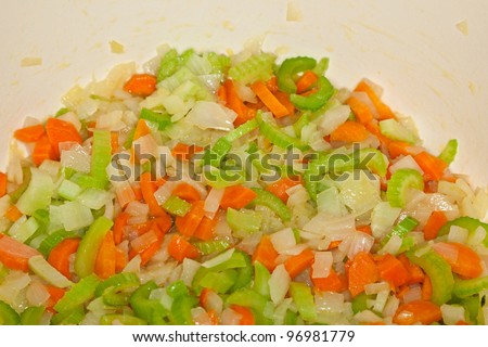 Freshly cut vegetables: onions, carrots, and celery.