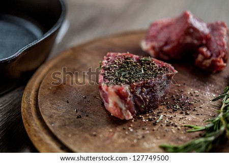 Seasoned tenderloin steak lying on the board