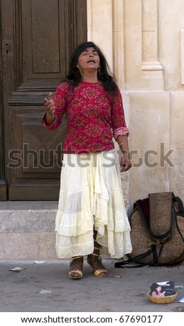 CAMARGUE,FRANCE, MAY 2007: Unidentified gypsy woman sings on street during the yearly gypsy pilgrimage to honor their patron Saint Marie Sarah on May 20, 2007, Saintes Maries de la Mer, France.