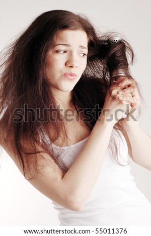 Hair problem. Girl with hairbrush
