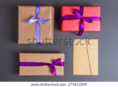 Three gift and envelope over blue paper background. Can be used in branding or mockup.