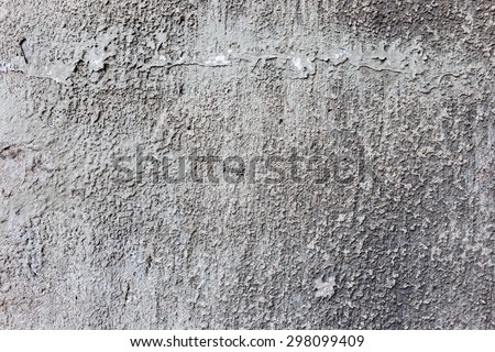 Stone wall background with cracked paint and holes