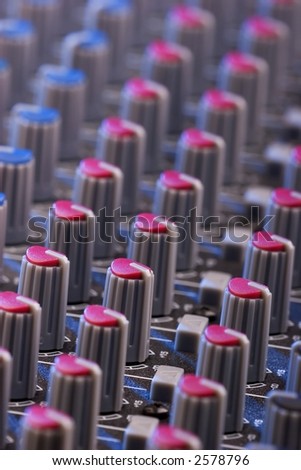 Close-up photo of a sound mixing board