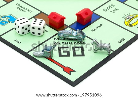 SWINDON, UK - JUNE 11, 2014: English Edition of Monopoly showing Pass Go, The classic trading game from Parker Brothers was first introduced to America in 1935.