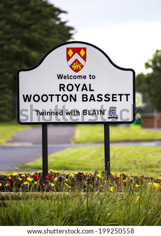 ROYAL WOOTTON BASSET, UK - JUNE 14, 2014: New Town Sign AfterThe town was granted royal patronage in recognition of its role in the military funeral repatriations, which passed through the town