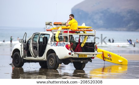POLZEATH, CORNWALL- UK - JULY 26 : RNLI Lifeguards on duty at Poleath Beach in Cornwall on July 26, 2014.