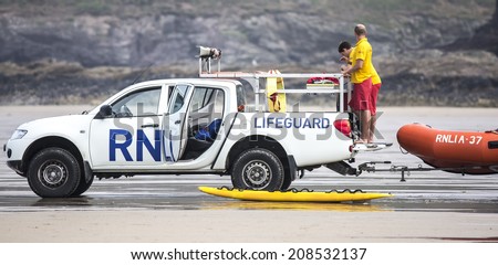 POLZEATH, CORNWALL- UK - JULY 26 : RNLI Lifeguards on duty at Poleath Beach in Cornwall on July 26, 2014.