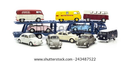 SWINDON, UK - DECEMBER 22, 2014:  Three Vintage VW Beetles  on a car Transporter on a white background.